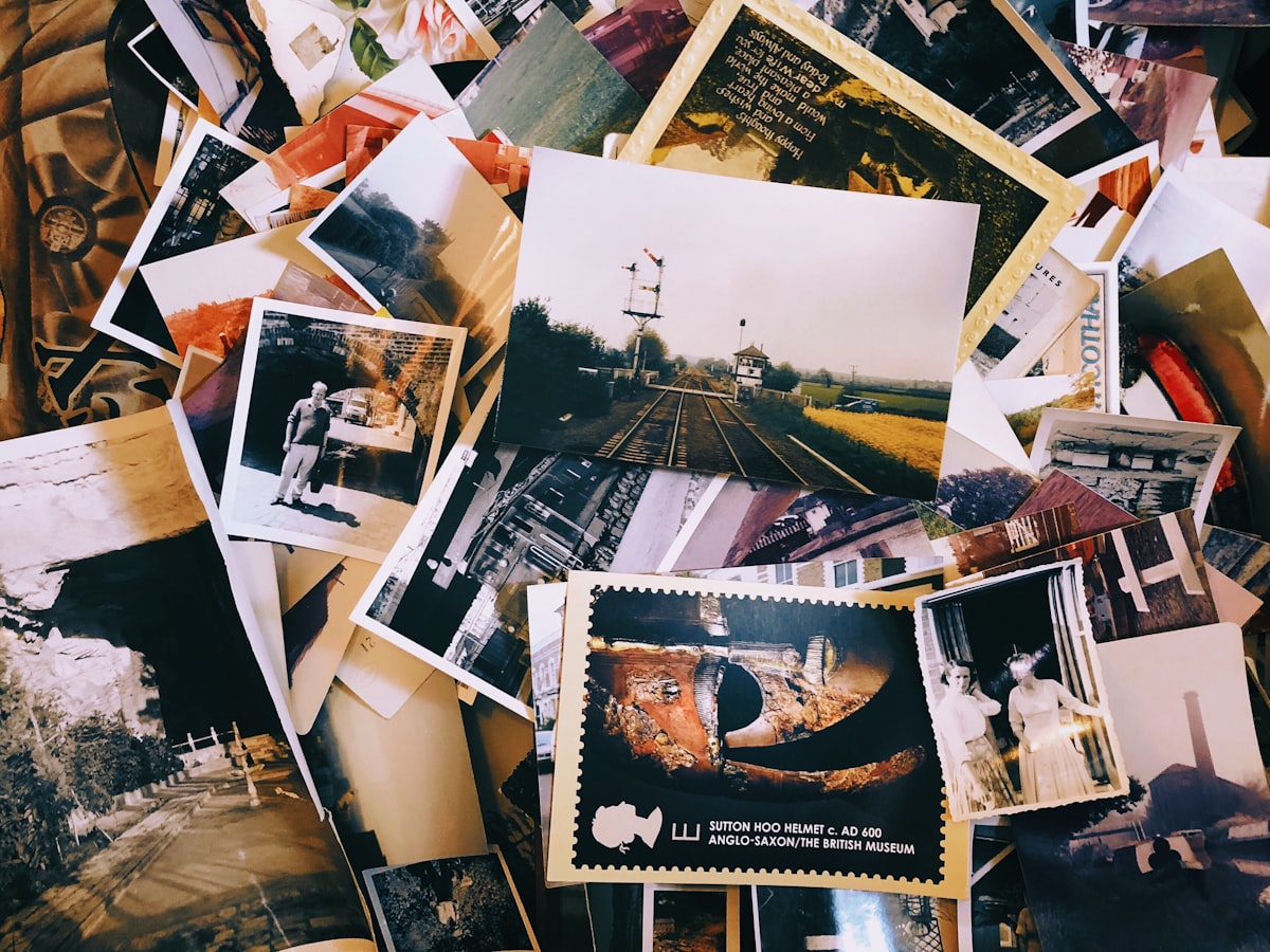 A pile of old family photographs and postcards